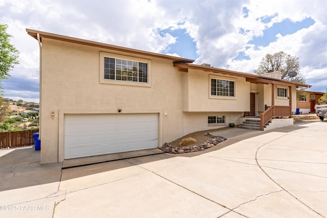2345 Shinnery Ln, Prescott, AZ 86301 - view of front facade with driveway, an attached garage, a chimney, and stucco siding