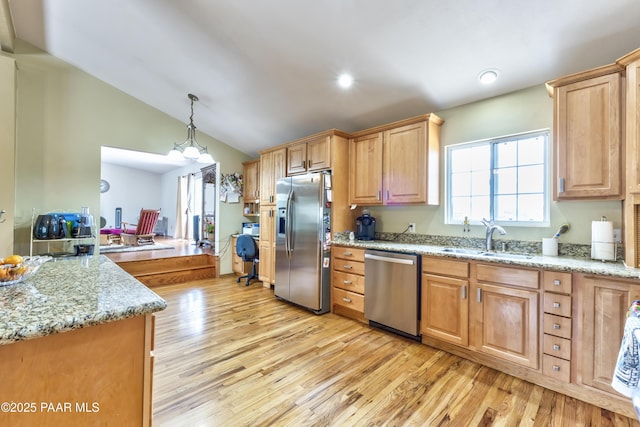 2345 Shinnery Ln, Prescott, AZ 86301 - kitchen featuring appliances with stainless steel finishes, light wood finished floors, light stone countertops, vaulted ceiling, and decorative light fixtures