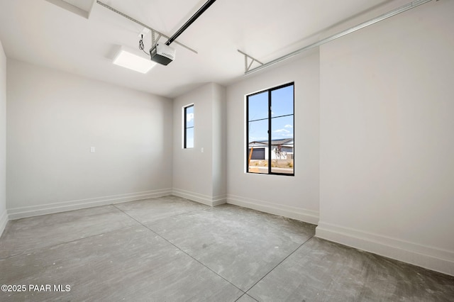 garage with baseboards and a garage door opener