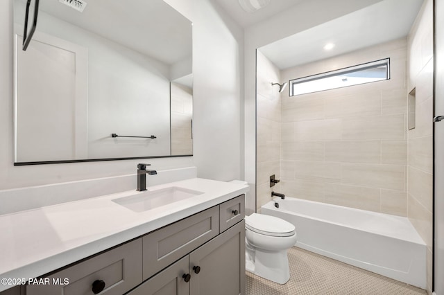 bathroom featuring toilet, vanity, visible vents, tile patterned floors, and tub / shower combination