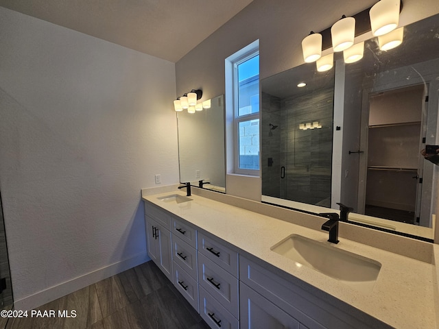 bathroom with hardwood / wood-style floors, vanity, and walk in shower