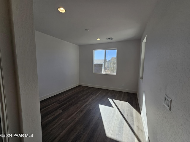 empty room featuring dark hardwood / wood-style flooring