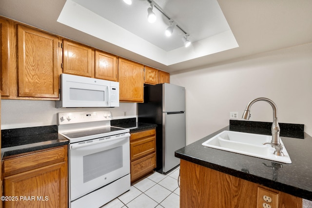 2180 Resort Way Unit S B, Prescott, AZ 86305 - kitchen with white appliances, a sink, a raised ceiling, light tile patterned floors, and brown cabinets