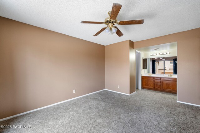 2180 Resort Way Unit S B, Prescott, AZ 86305 - unfurnished bedroom with light carpet, baseboards, connected bathroom, a textured ceiling, and ceiling fan