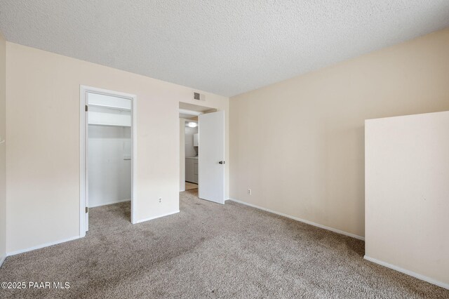 2180 Resort Way Unit S B, Prescott, AZ 86305 - unfurnished bedroom featuring carpet, a spacious closet, a textured ceiling, baseboards, and a closet