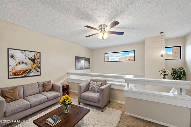 2180 Resort Way Unit S B, Prescott, AZ 86305 - living room featuring light colored carpet, healthy amount of natural light, a ceiling fan, baseboards, and a textured ceiling