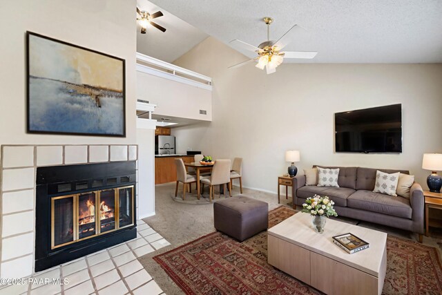2180 Resort Way Unit S B, Prescott, AZ 86305 - tiled living room featuring ceiling fan, a glass covered fireplace, carpet, high vaulted ceiling, and baseboards