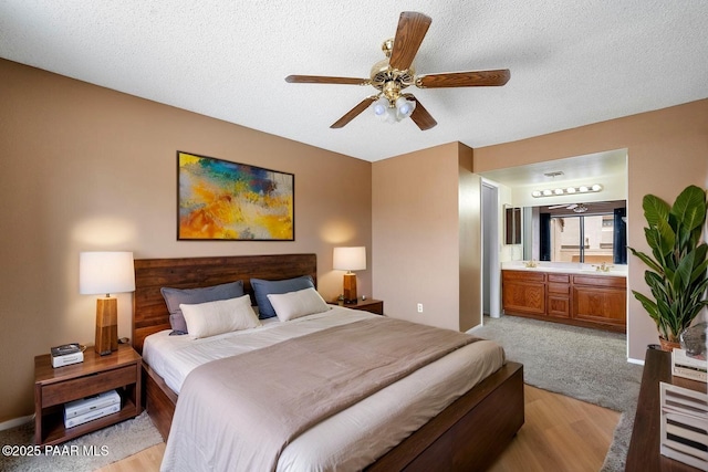 2180 Resort Way Unit S B, Prescott, AZ 86305 - bedroom featuring ensuite bath, a textured ceiling, light wood-style flooring, ceiling fan, and baseboards