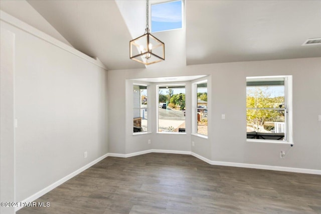 interior space with dark wood-type flooring, lofted ceiling, and an inviting chandelier