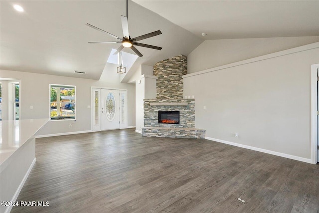 unfurnished living room with a fireplace, dark wood-type flooring, ceiling fan, and lofted ceiling