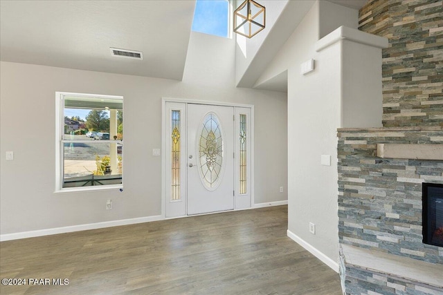 entrance foyer featuring a fireplace and dark hardwood / wood-style floors