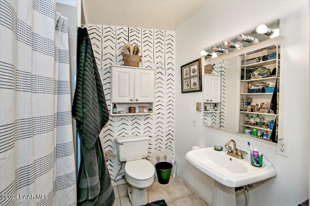 bathroom with tile patterned floors, a shower with curtain, and toilet