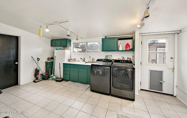 laundry area featuring sink, light tile patterned floors, rail lighting, and washing machine and clothes dryer