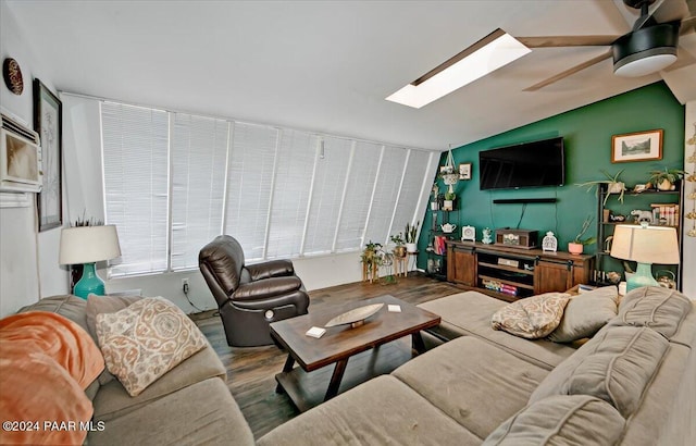 living room with hardwood / wood-style floors, ceiling fan, and lofted ceiling