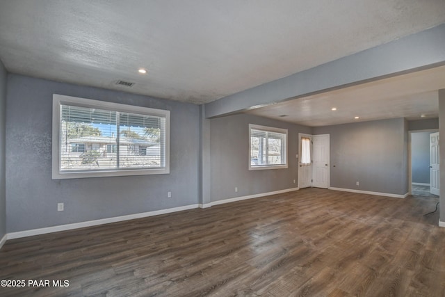 spare room with dark wood-style floors, recessed lighting, visible vents, and baseboards