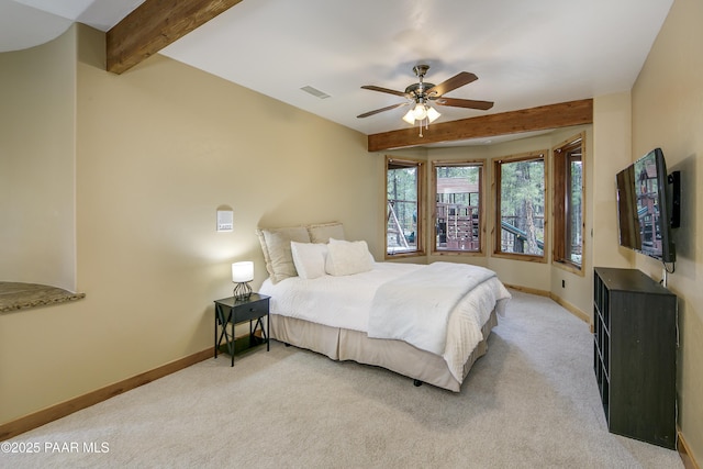 bedroom featuring ceiling fan, light carpet, and beamed ceiling