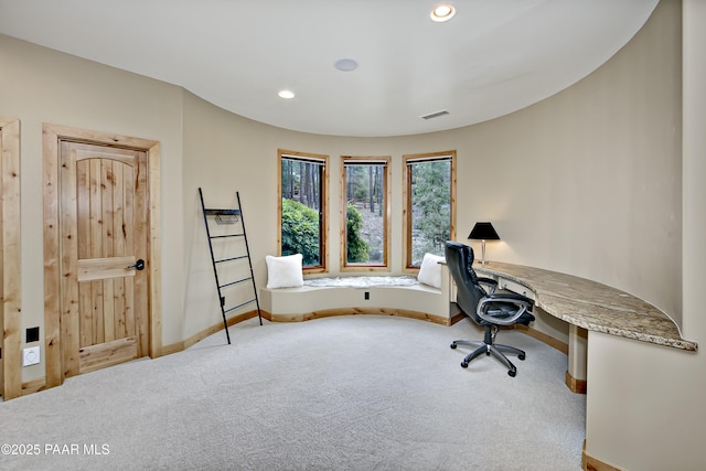 office space featuring built in desk and carpet floors