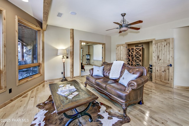 living room with ceiling fan and light wood-type flooring