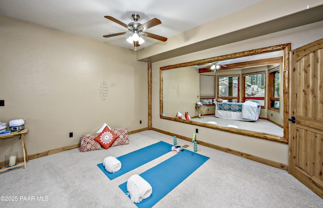 workout room featuring ceiling fan and carpet flooring