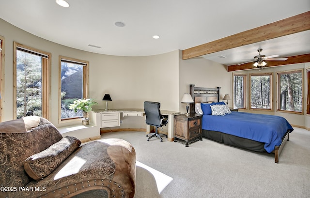 carpeted bedroom with beam ceiling and ceiling fan