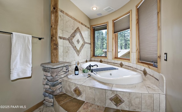 bathroom featuring a relaxing tiled tub