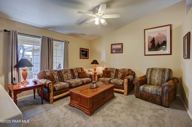 living area featuring vaulted ceiling, baseboards, visible vents, and light colored carpet