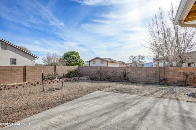 view of yard featuring a patio area and a fenced backyard