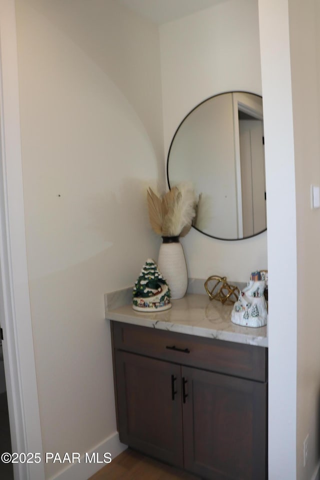 bathroom with vanity and wood-type flooring