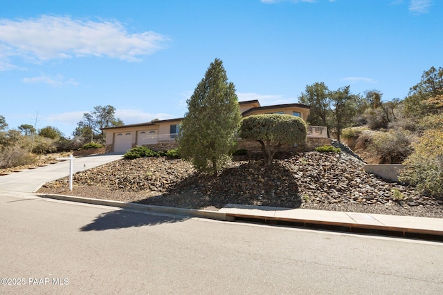 view of front facade with concrete driveway and a garage