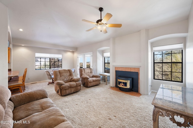 carpeted living room featuring ceiling fan and plenty of natural light