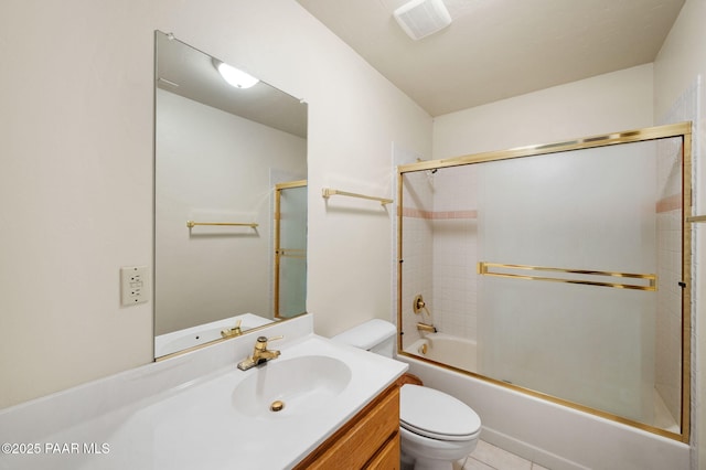 full bathroom featuring vanity, tile patterned floors, enclosed tub / shower combo, and toilet