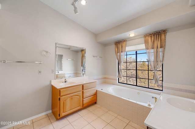 bathroom featuring lofted ceiling, vanity, tiled bath, and tile patterned flooring