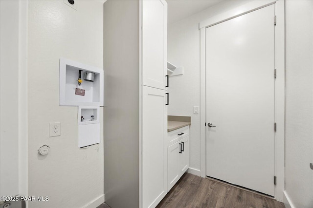 interior space featuring dark hardwood / wood-style floors, cabinets, and hookup for a washing machine