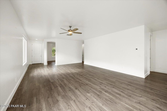 unfurnished living room with dark hardwood / wood-style floors and ceiling fan