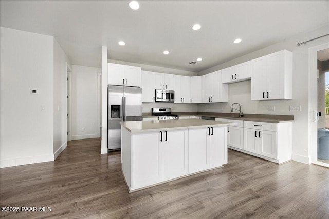 kitchen featuring white cabinetry, a center island, and appliances with stainless steel finishes