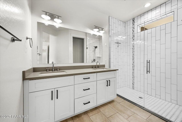 bathroom with vanity and a shower with door