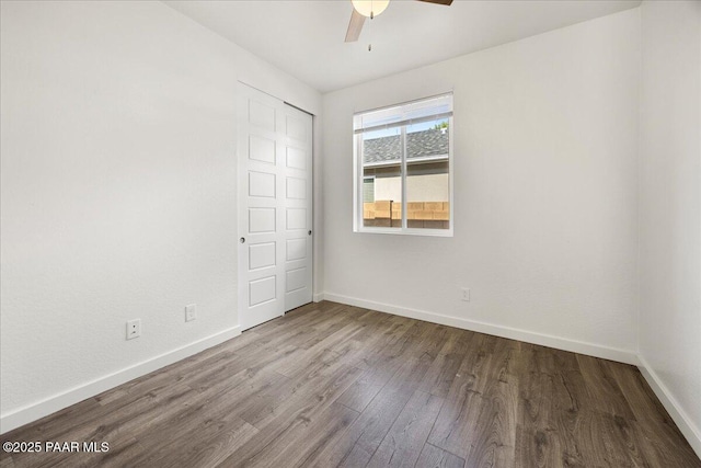 unfurnished bedroom with ceiling fan, a closet, and wood-type flooring