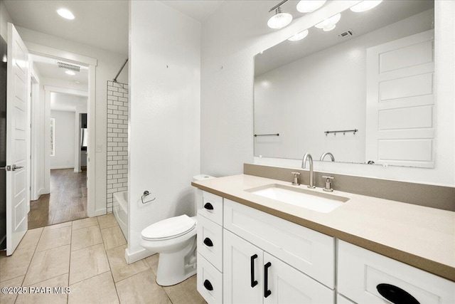 full bathroom with tile patterned flooring, vanity, toilet, and tiled shower / bath combo