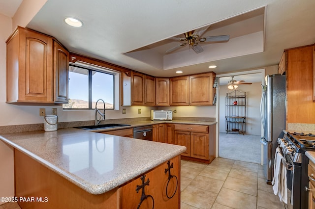 1086 N Broken Wagon Trl, Dewey-Humboldt, AZ 86327 - kitchen featuring stainless steel appliances, a tray ceiling, ceiling fan, brown cabinetry, and recessed lighting