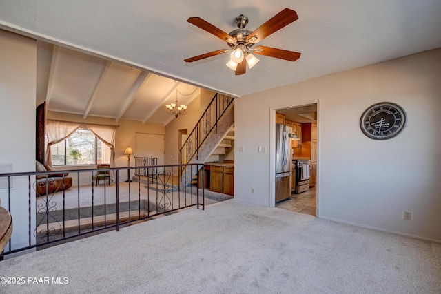 1086 N Broken Wagon Trl, Dewey-Humboldt, AZ 86327 - unfurnished living room featuring carpet floors, a ceiling fan, a chandelier, lofted ceiling, and stairs