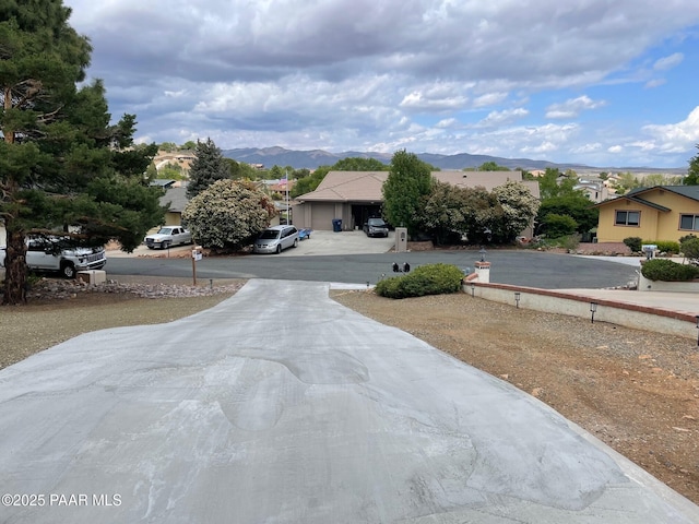 1086 N Broken Wagon Trl, Dewey-Humboldt, AZ 86327 - view of concrete driveway featuring a mountain view and a residential view