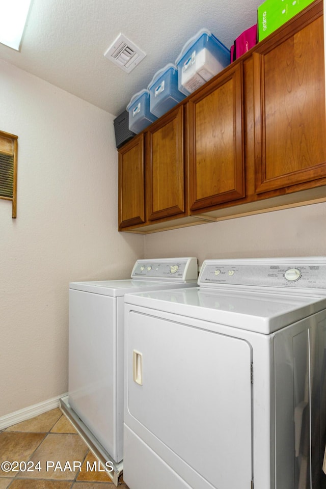 1716 Alpine Meadows Ln Unit 403, Prescott, AZ 86303 - laundry area with washer and dryer, cabinet space, baseboards, and light tile patterned floors