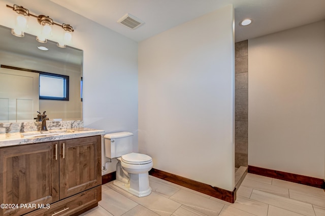 bathroom with vanity, toilet, and walk in shower