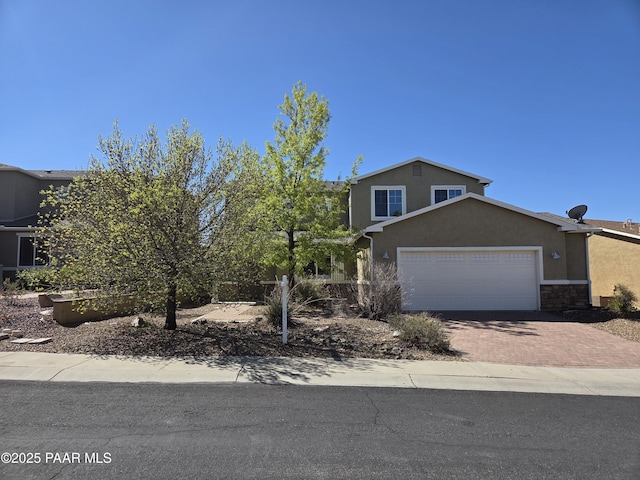 13085 E Ramos St, Dewey-Humboldt, AZ 86327 - view of front of home featuring stucco siding, decorative driveway, and a garage