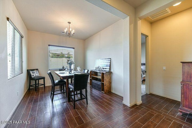 13085 E Ramos St, Dewey-Humboldt, AZ 86327 - dining room with dark wood-style floors, baseboards, visible vents, and a chandelier