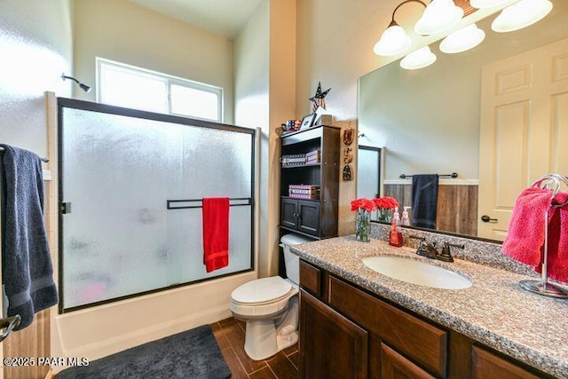13085 E Ramos St, Dewey-Humboldt, AZ 86327 - bathroom with toilet, an inviting chandelier, wood finished floors, combined bath / shower with glass door, and vanity