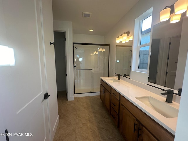 bathroom featuring tile patterned floors, vanity, and an enclosed shower