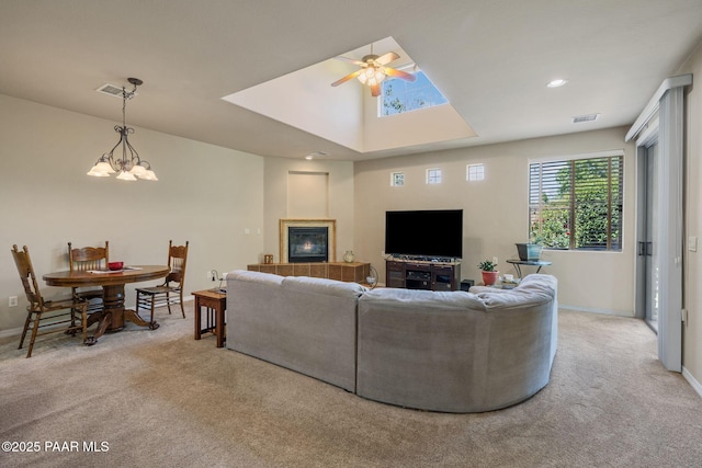 1222 Crown Ridge Dr, Prescott, AZ 86301 - living room featuring carpet flooring, a ceiling fan, a fireplace, and a chandelier