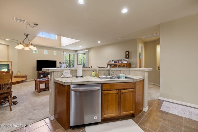 1222 Crown Ridge Dr, Prescott, AZ 86301 - kitchen with dishwasher, carpet, tile counters, open floor plan, and brown cabinets