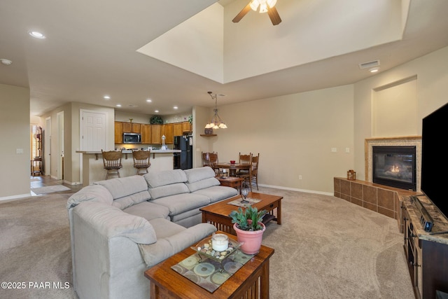 1222 Crown Ridge Dr, Prescott, AZ 86301 - living area featuring light colored carpet, recessed lighting, a tile fireplace, and ceiling fan